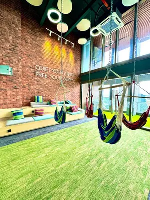 a gym with swings in a room with a brick wall at Riveria City near KL Sentral with 118 view Sky Infinity Pool by COBNB in Kuala Lumpur