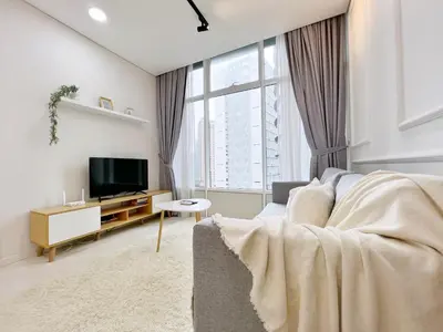 a living room with a couch and a tv at Sky Suites Airy 2BR Suite at KLCC in Kuala Lumpur