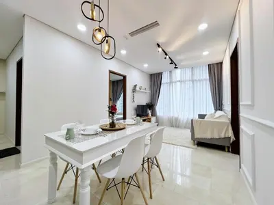a white dining room with a white table and chairs at Sky Suites Airy 2BR Suite at KLCC in Kuala Lumpur