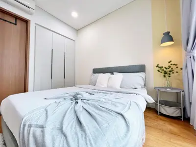 a bedroom with a bed with a blue blanket at Sky Suites Airy 2BR Suite at KLCC in Kuala Lumpur
