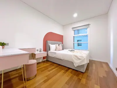 a bedroom with a bed and a window at Sky Suites Blush 3BR Suite at KLCC in Kuala Lumpur