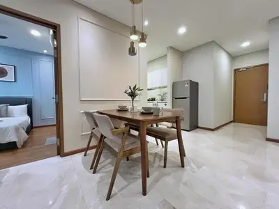 a kitchen and dining room with a table and chairs at Sky Suites Calm 2BR Suite at KLCC in Kuala Lumpur