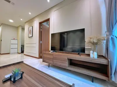 a living room with a large flat screen tv at Sky Suites Calm 2BR Suite at KLCC in Kuala Lumpur