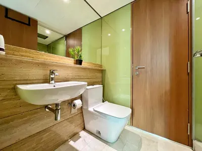 a bathroom with a toilet and a sink at Sky Suites Calm 2BR Suite at KLCC in Kuala Lumpur