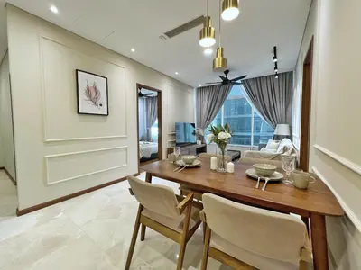 a dining room with a table and chairs at Sky Suites Calm 2BR Suite at KLCC in Kuala Lumpur
