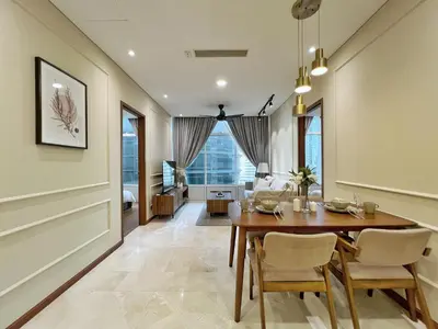 a dining room with a table and chairs at Sky Suites Calm 2BR Suite at KLCC in Kuala Lumpur