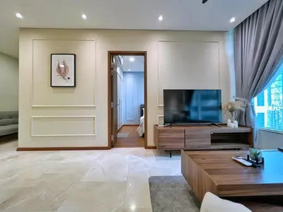 a living room with a television and a table at Sky Suites Calm 2BR Suite at KLCC in Kuala Lumpur