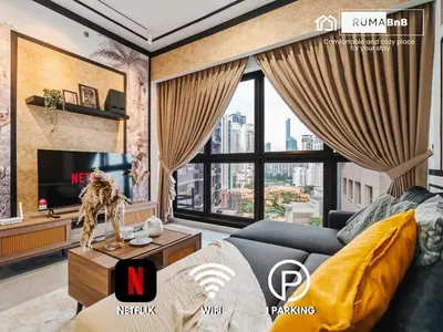 a living room with a couch and a tv at Modern Art 2BR Agile Bukit Bintang by RumaBnB in Kuala Lumpur