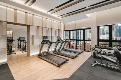 a gym with a row of treadmills and exercise machines at Modern Art 2BR Agile Bukit Bintang by RumaBnB in Kuala Lumpur