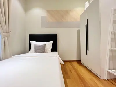 a small bedroom with a bed and a staircase at Sky Suites Centrale 3BR Suite at KLCC in Kuala Lumpur