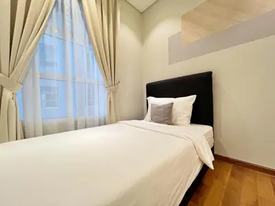 a bedroom with a large white bed with a window at Sky Suites Centrale 3BR Suite at KLCC in Kuala Lumpur