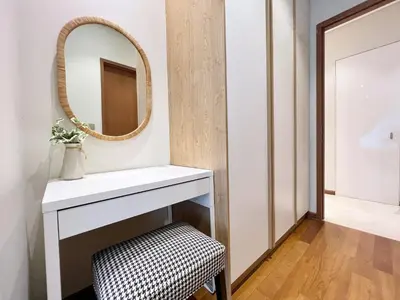 a bathroom with a mirror and a stool at Sky Suites Centrale 3BR Suite at KLCC in Kuala Lumpur