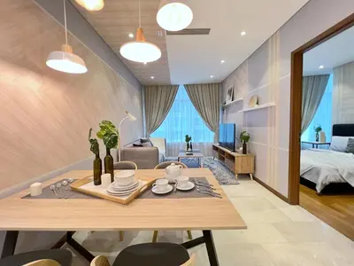 a dining room with a table and a bedroom at Sky Suites Centrale 3BR Suite at KLCC in Kuala Lumpur
