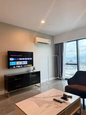 a living room with a couch and a tv at Facestyle Infinity Pool KLCC Smart TV Free WiFi Two Bedroom in Kuala Lumpur