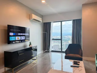 a living room with a chair and a large window at Facestyle Infinity Pool KLCC Smart TV Free WiFi Two Bedroom in Kuala Lumpur