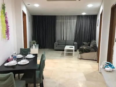 a living room with a table and a couch at KL Suites Apartment at Vortex in Kuala Lumpur