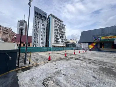 a parking lot with orange cones in front of buildings at TEEDO Hotel Kuala Lumpur in Kuala Lumpur