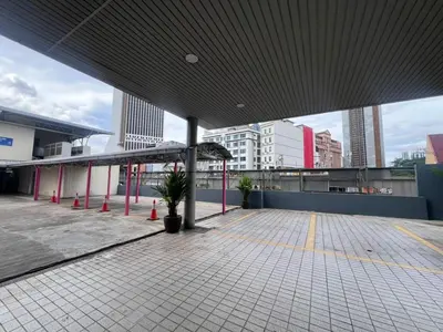 an empty parking lot with a large building at TEEDO Hotel Kuala Lumpur in Kuala Lumpur