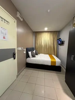 a small room with a bed with a window at SS Grey Hotel Bukit Bintang in Kuala Lumpur