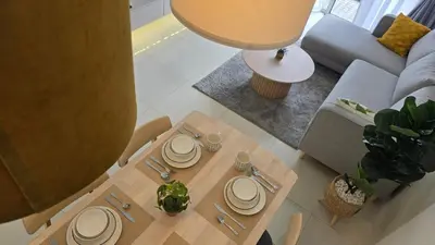 a table with plates on it in a living room at Bintang Goldhill Near TRX & Pavilion Mall,MRT,KL By Proplet in Kuala Lumpur