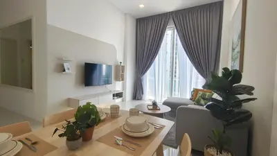 a living room with a table and a couch and a tv at Bintang Goldhill Near TRX & Pavilion Mall,MRT,KL By Proplet in Kuala Lumpur