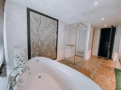 a bathroom with a bath tub and a shower at Deluxe Family Suites w KLCC View in Kuala Lumpur