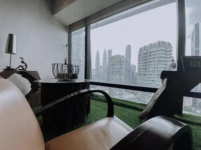 a room with a large window with a view of a city at Deluxe Family Suites w KLCC View in Kuala Lumpur