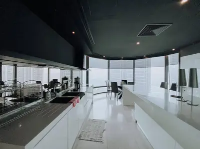 an office with a long counter with tables and chairs at Deluxe Family Suites w KLCC View in Kuala Lumpur