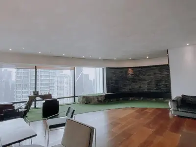 a living room with a couch and chairs in a building at Deluxe Family Suites w KLCC View in Kuala Lumpur