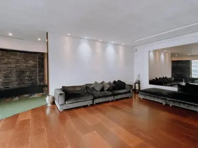 a living room with two couches and a large wall at Deluxe Family Suites w KLCC View in Kuala Lumpur