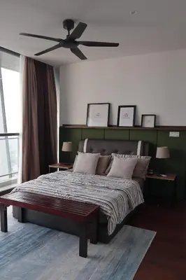 a bedroom with a bed with a ceiling fan at The Bohomes with KLCC view in Kuala Lumpur