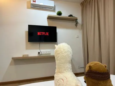 two teddy bears are watching tv in a room at Relaxing Muji Retreat with Jacuzzi, Retro Games, MRT in Kuala Lumpur
