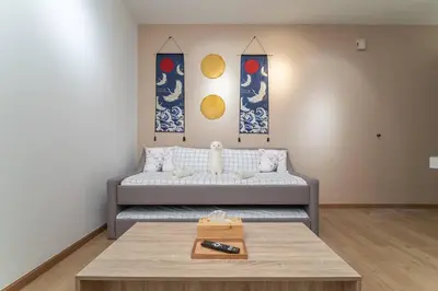 a living room with a couch and a coffee table at Relaxing Muji Retreat with Jacuzzi, Retro Games, MRT in Kuala Lumpur