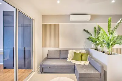 a living room with a couch and some plants at Quill Residence Luxury Suite Kuala Lumpur by Cobnb in Kuala Lumpur