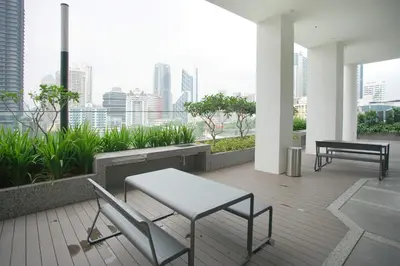 a patio with a table and chairs on a balcony at Quill Residence Luxury Suite Kuala Lumpur by Cobnb in Kuala Lumpur