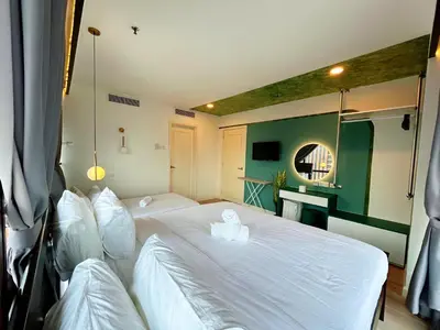 a bedroom with two beds with white sheets at Times Square by Manhattan Group in Kuala Lumpur