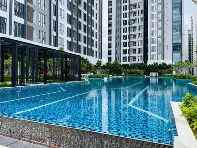 a large swimming pool in a city with tall buildings at Sentral Suites By Eassy Hotel in Kuala Lumpur