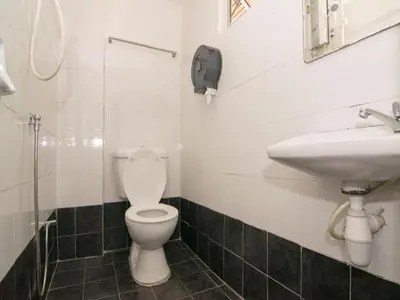 a bathroom with a toilet and a sink at OYO 103 V'la Garden Hotel in Kuala Lumpur