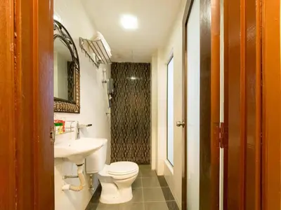a bathroom with a white toilet and a sink at OYO 126 Rae Hotel in Kuala Lumpur