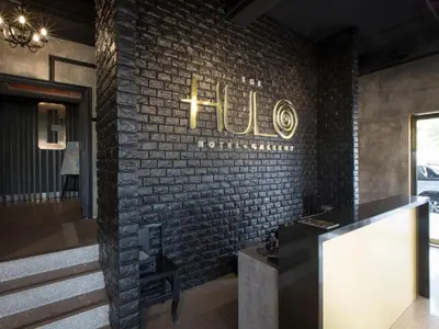 a brick wall with a hotel sign on it at The Hulo Hotel & Gallery in Kuala Lumpur