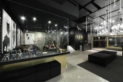 a room with a chandelier and a display case at The Hulo Hotel & Gallery in Kuala Lumpur