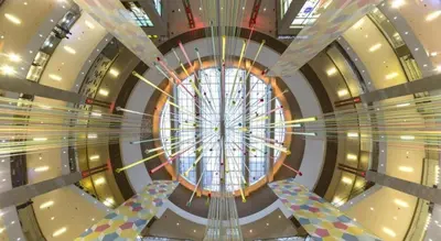 a spiral staircase in a building with a large window at OYO 264 City Edge Hotel in Kuala Lumpur
