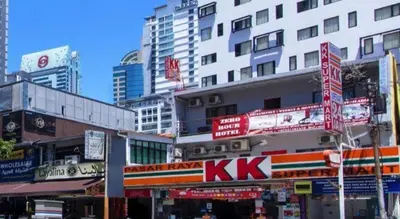 a busy city street with tall buildings and signs at OYO 304 Zero Hour Hotel in Kuala Lumpur