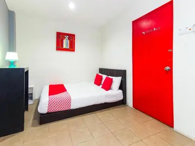 a bedroom with a red door and a bed at OYO 304 Zero Hour Hotel in Kuala Lumpur