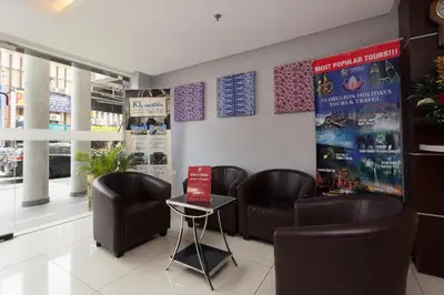a waiting room with leather chairs and a table at ZEN Rooms Metro Hotel @ KL Sentral in Kuala Lumpur