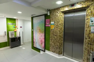 a hallway with a large painting on the wall at Suka Kota Hotel in Kuala Lumpur