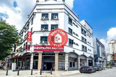 a white building with a red sign on it at OYO 1045 Azimuth Hotel in Kuala Lumpur