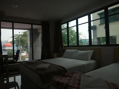 a hotel room with two beds and a window at Budget Star Hotel in Kuala Lumpur
