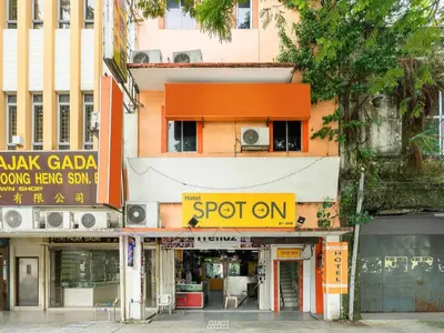 an orange building with a spot on sign on a street at SPOT ON 89616 My Trillion Hotel in Kuala Lumpur