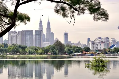a view of the kuala lumpur city skyline from across a lake at OYO 90106 Sindbad Hotel in Kuala Lumpur